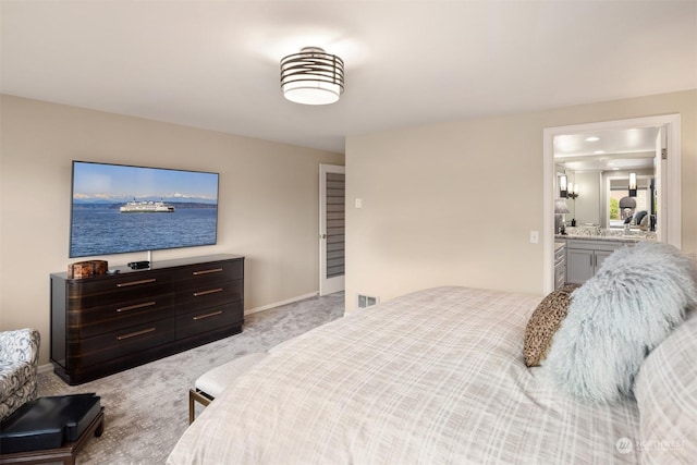 carpeted bedroom featuring connected bathroom