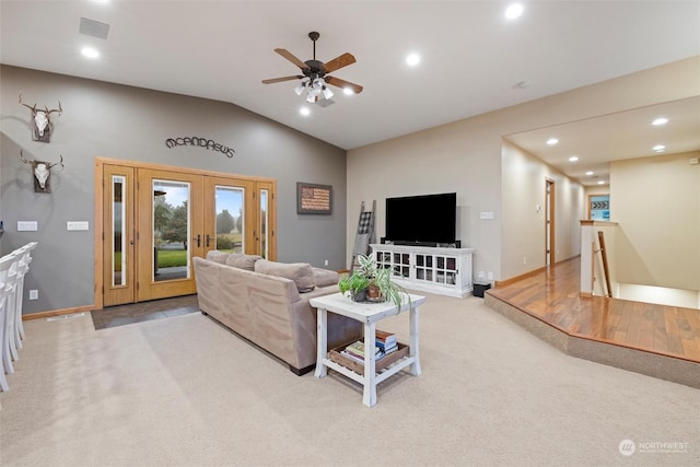 living room with ceiling fan, light colored carpet, lofted ceiling, and french doors