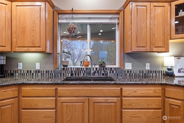 kitchen with sink and dark stone counters