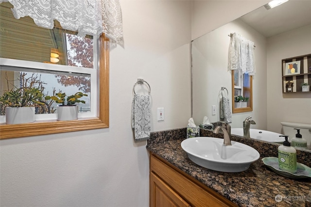 bathroom featuring vanity and toilet