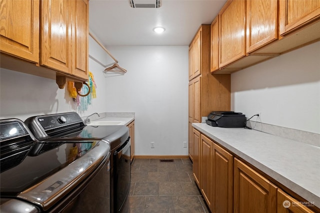 laundry area featuring sink, cabinets, and independent washer and dryer