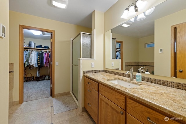 bathroom with vanity and a shower with shower door