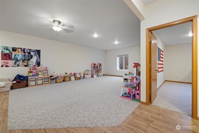 recreation room with light colored carpet