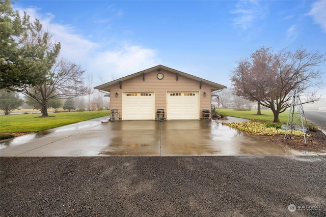 view of side of property featuring a yard, an outdoor structure, and a garage