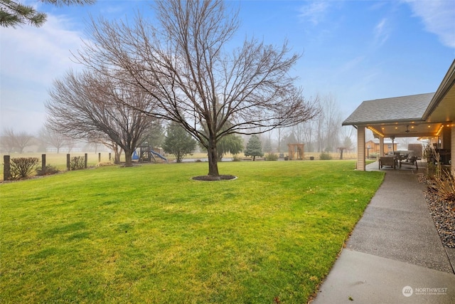 view of yard featuring ceiling fan and a patio