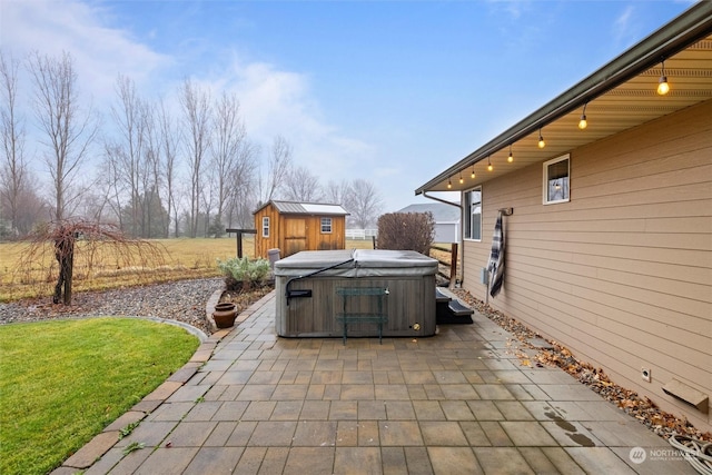 view of patio / terrace featuring an outbuilding and a hot tub