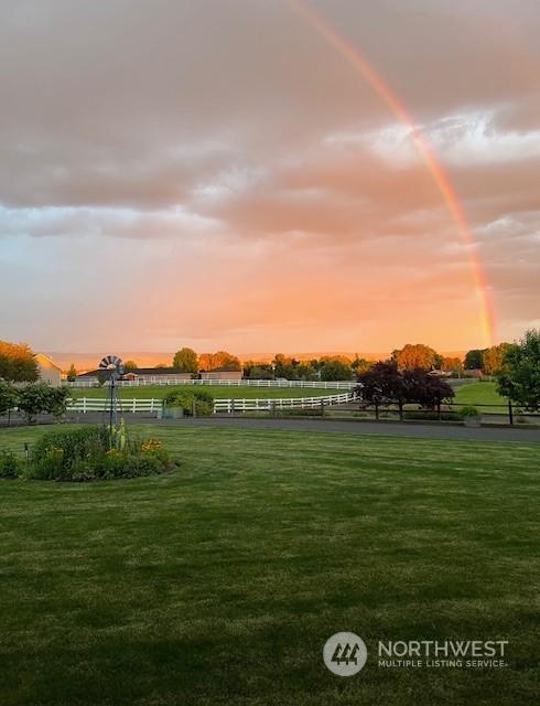 view of property's community with a yard and a rural view