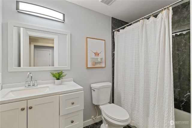 bathroom featuring vanity and toilet