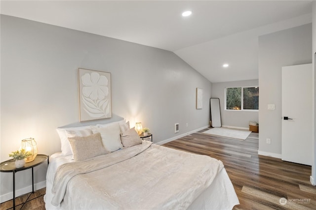 bedroom featuring dark hardwood / wood-style floors and lofted ceiling