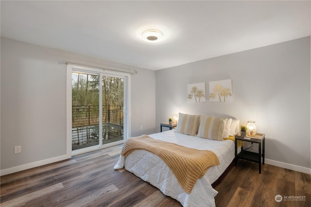 bedroom with dark hardwood / wood-style floors and access to exterior