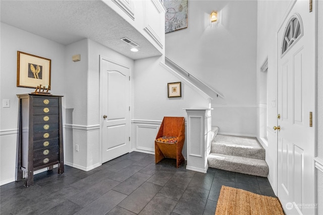 foyer entrance featuring a textured ceiling