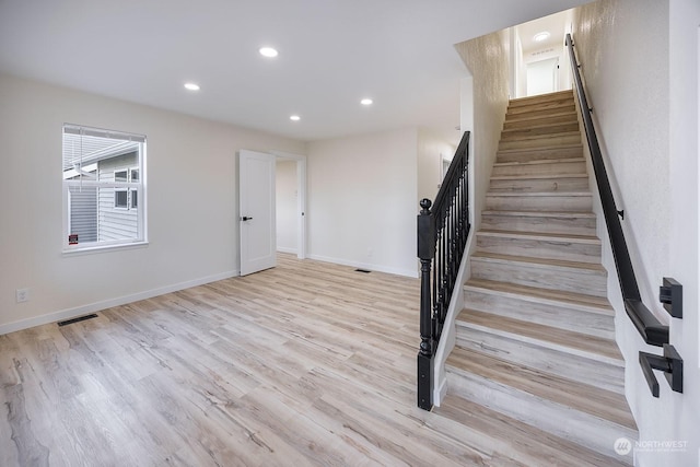 stairs with hardwood / wood-style flooring