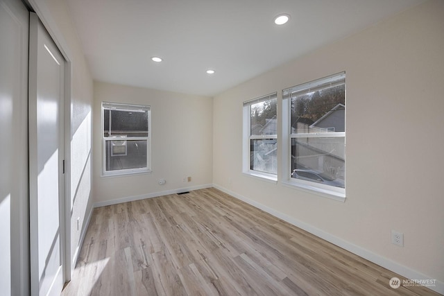 unfurnished room with light hardwood / wood-style floors