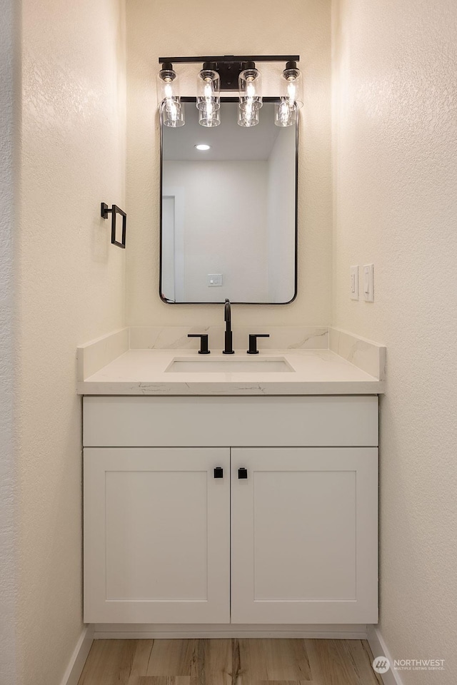 bathroom featuring vanity and wood-type flooring