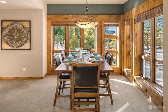 dining area featuring light carpet