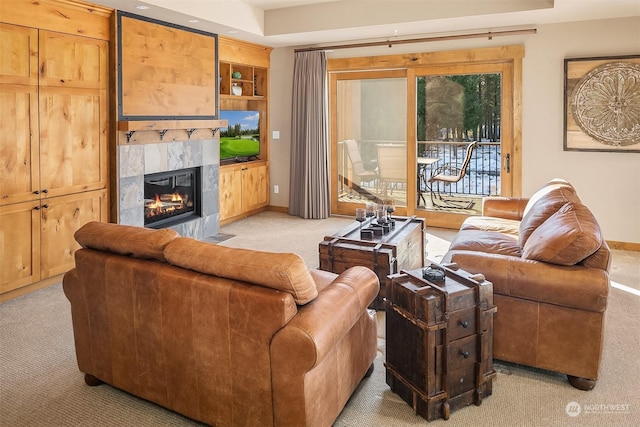 carpeted living room with a tiled fireplace