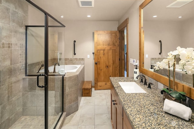 bathroom featuring vanity, tile patterned flooring, and independent shower and bath