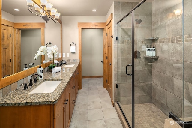 bathroom featuring a shower with door, vanity, tile patterned floors, and a chandelier