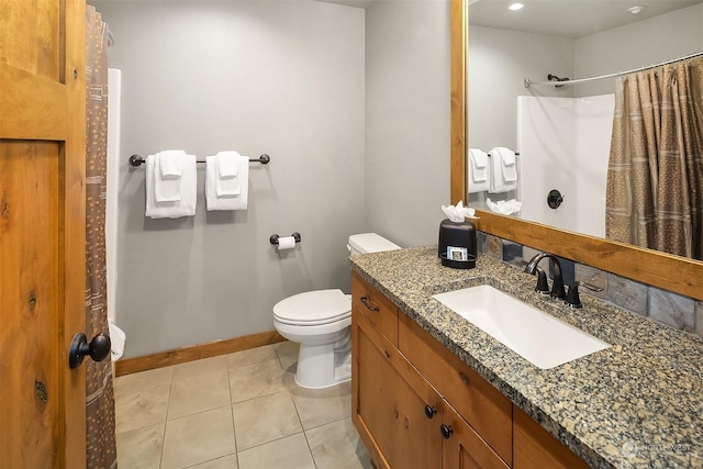 bathroom featuring toilet, vanity, tile patterned floors, and a shower with curtain