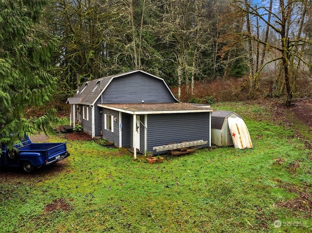 view of home's exterior featuring a shed and a lawn