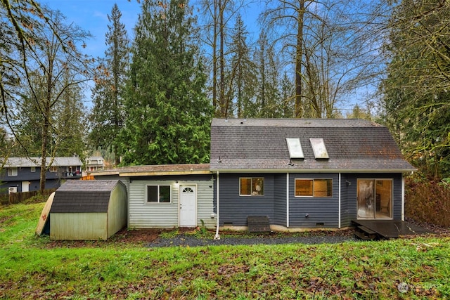 rear view of house featuring a shed