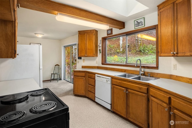 kitchen featuring white appliances and sink