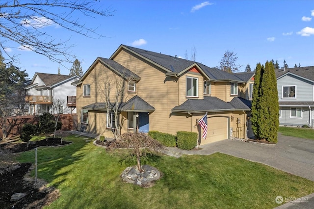 view of front of home featuring a balcony, a garage, and a front yard