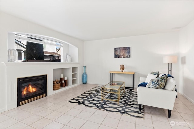 living room featuring built in features and light tile patterned floors