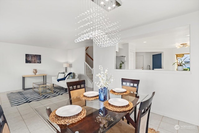 dining room with light tile patterned floors and a chandelier