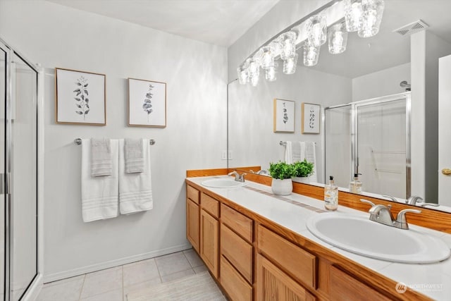 bathroom featuring an enclosed shower, vanity, and tile patterned floors