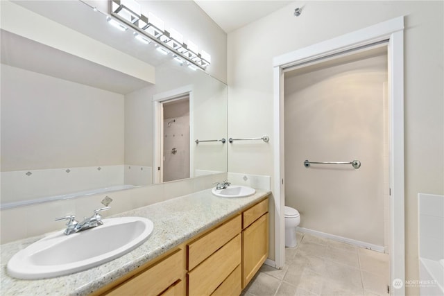 bathroom featuring a tub, tile patterned flooring, vanity, and toilet