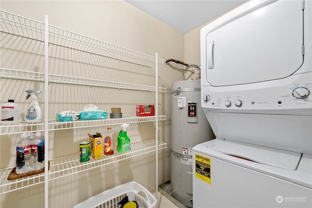 clothes washing area with stacked washer and dryer and water heater