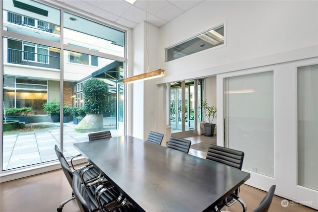 dining space with a drop ceiling