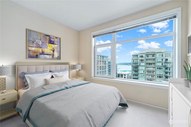 carpeted bedroom featuring a water view