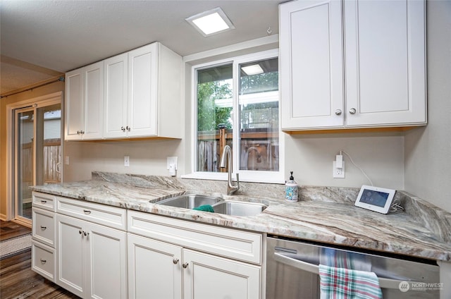 kitchen featuring sink, white cabinetry, light stone counters, stainless steel dishwasher, and dark hardwood / wood-style flooring