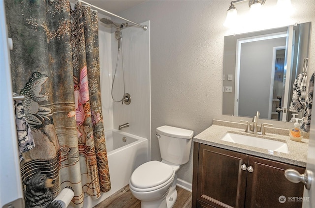 full bathroom featuring hardwood / wood-style flooring, vanity, shower / bath combo, and toilet