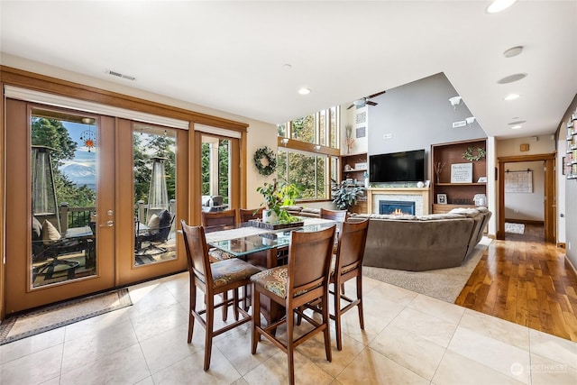 dining space with french doors, light tile patterned floors, and ceiling fan