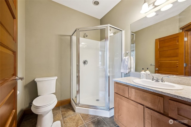 bathroom with vanity, toilet, and an enclosed shower