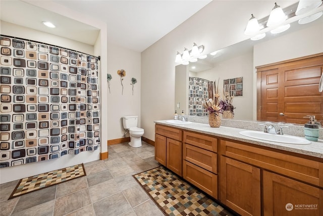 bathroom featuring vanity, a shower with shower curtain, and toilet