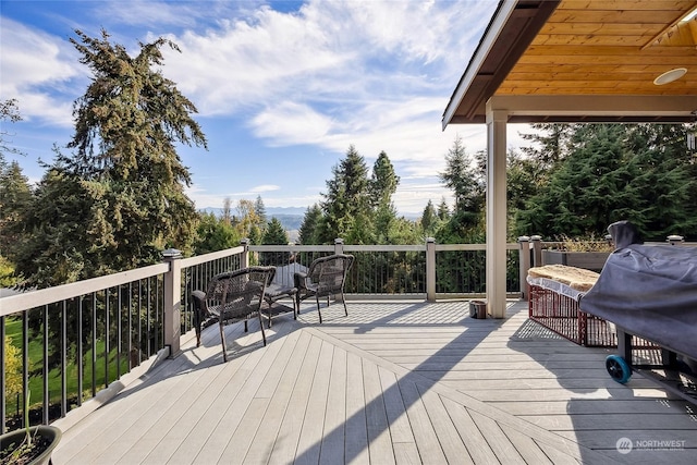 wooden terrace featuring grilling area