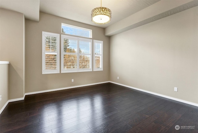 spare room with dark hardwood / wood-style flooring