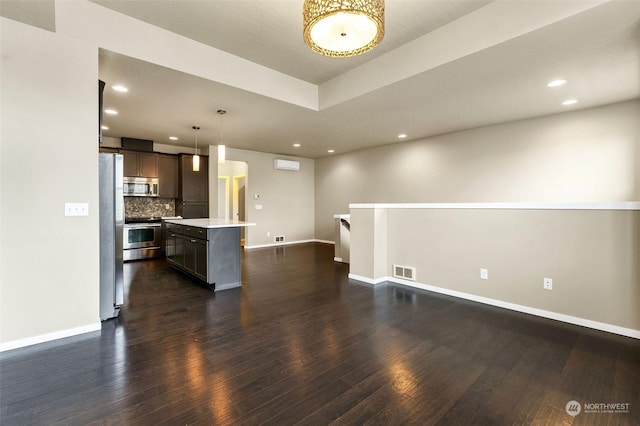 unfurnished living room with dark wood-type flooring