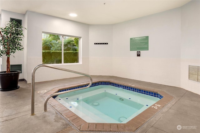 view of pool with an indoor hot tub