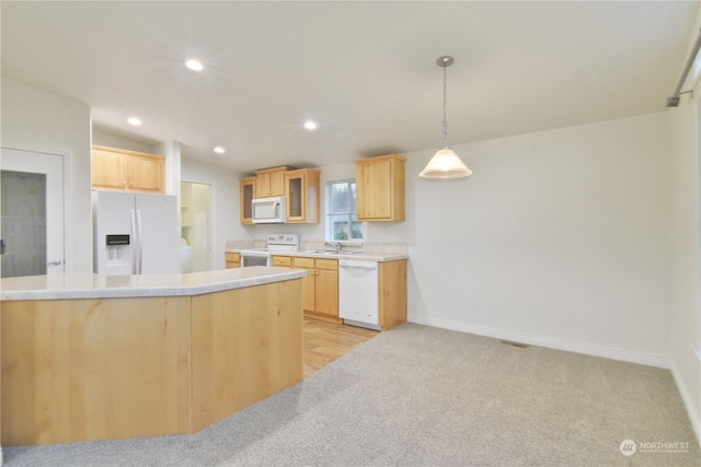 kitchen with light brown cabinets, vaulted ceiling, decorative light fixtures, white appliances, and light carpet