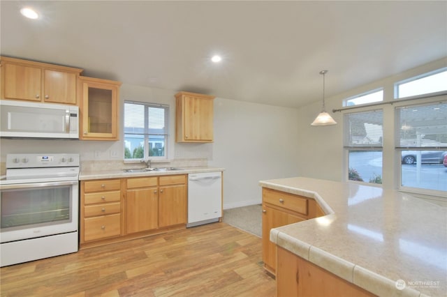 kitchen with sink, pendant lighting, white appliances, and light brown cabinets