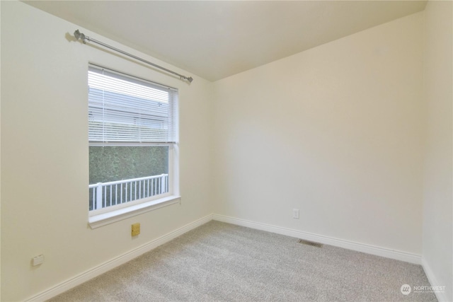 empty room featuring light carpet