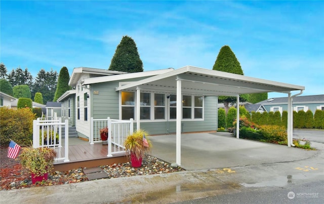 back of house with a carport