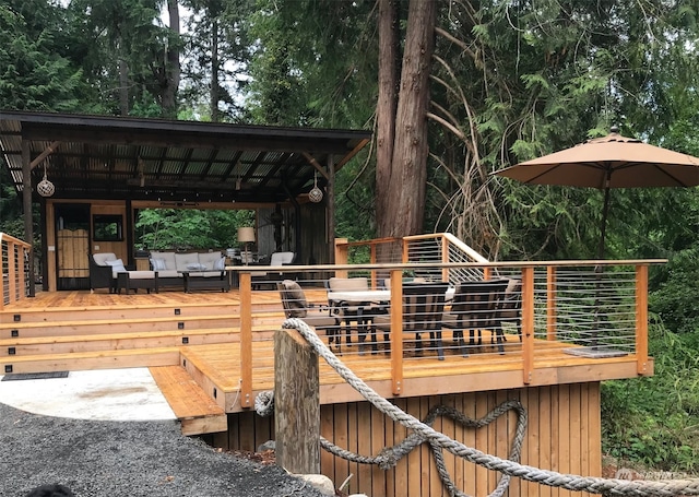 wooden deck featuring outdoor lounge area and a bar