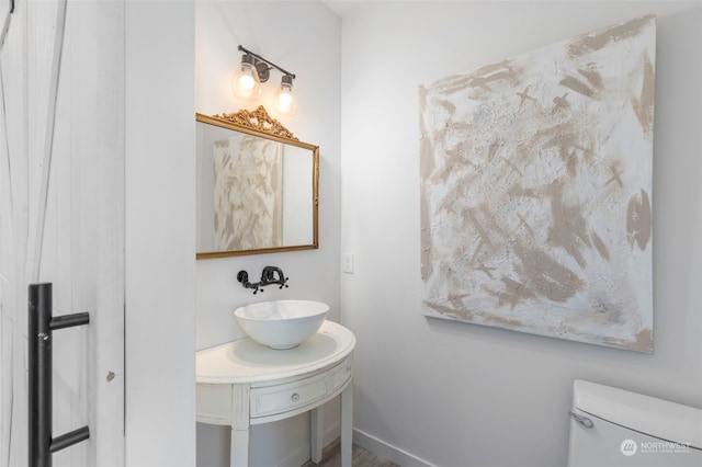 bathroom featuring sink and toilet