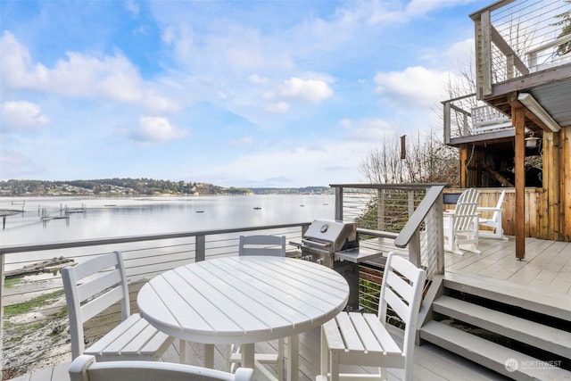 wooden deck with a grill and a water view